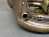 a brass trumpet with a rope attached to it