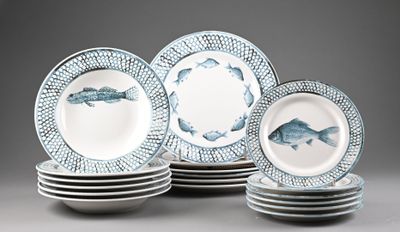 several plates with fish designs are stacked on top of each other