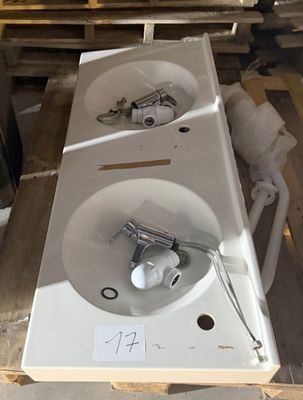 two sinks sitting on a pallet in a warehouse