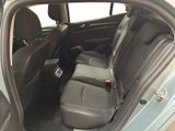 the back seats of a car with the door open and the driver ' s seat down