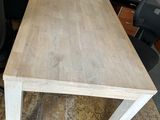 a wooden table with a black chair next to it