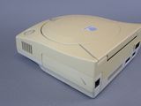 a white game console sitting on a gray surface