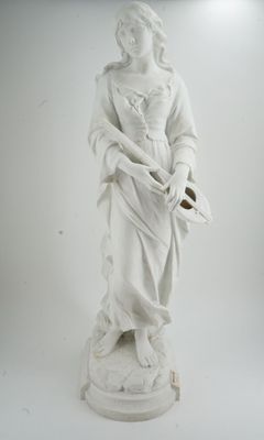a white statue of a woman holding a basket