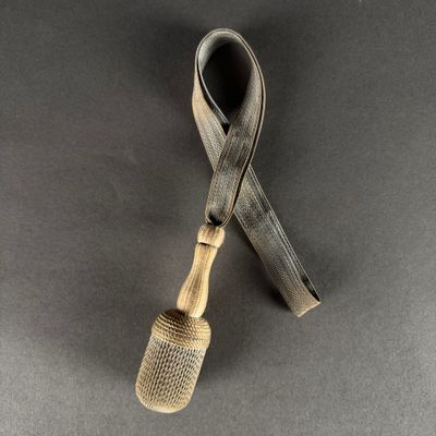 a close up of a small pipe with a metal handle