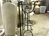 a metal stand that has a candle holder on it