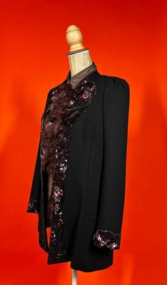 an image of a black jacket on a mannequin with a red background
