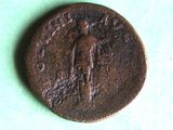 an old coin with a man on it on a green surface