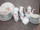 a lot of plates and cups that are on the table