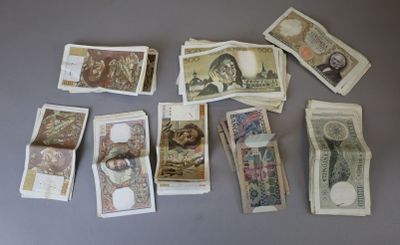many different types of paper money on the table