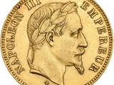 a close up of a gold coin with a man ' s face on it