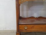 a small wooden table with a mirror on top of it