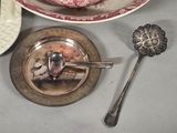 a plate with a piece of cake on it next to a spoon and a plate with a piece of cake on it