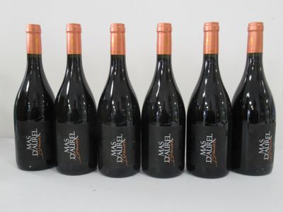 six bottles of wine are lined up on a white surface