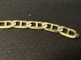a close up of a gold chain on a black surface