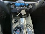 a car dashboard with a radio and a remote control in it