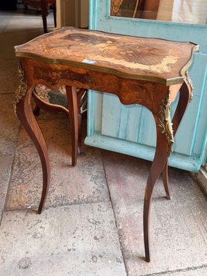 a small table with a mirror on top of it
