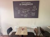 tables and chairs in a room with a chalk board on the wall