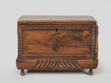 an old wooden chest with a drawer on top of it
