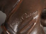 a bronze statue of a dog with a collar on