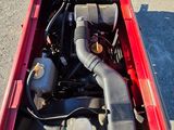 a small engine in the back of a red truck