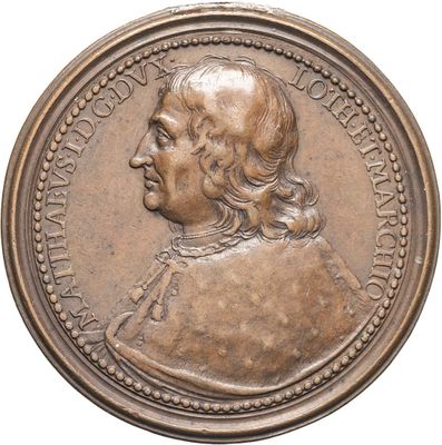 an old bronze medal with a man ' s face on it