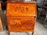 a wooden dresser with a drawer on top of it