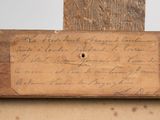 an old piece of wood with writing on it