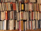 a lot of dvds stacked on a shelf in a room