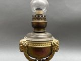 an old fashioned oil lamp with a glass bulb on top of it