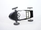a toy car that is sitting on wheels on a white surface