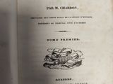 an old book that is open on a table