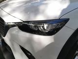 a white car parked on the side of the road