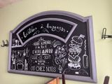 a chalk board on the wall of a restaurant