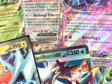 several pokemon cards sitting on top of each other on a table