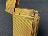 a gold lighter that is sitting on a table