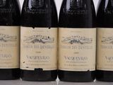 six bottles of wine are lined up in a row on a table