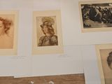 many old photographs of women on display on a table