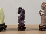 three figurines of a woman, a man and a dog on a table