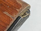 a close up of a wooden table with a metal handle