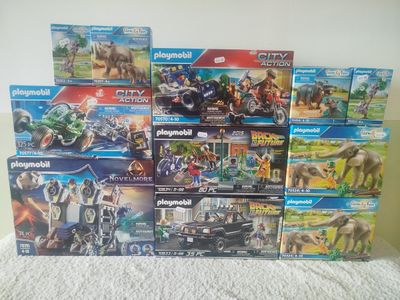 a lot of playmobil toys sitting on a bed