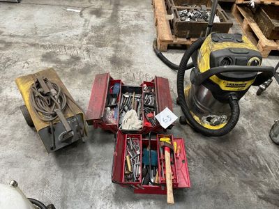 many tools that are sitting on the floor next to a vacuum