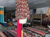 many different types of fabrics on display in a store
