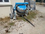 a cement mixer sitting on the side of a building