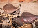 a old motorcycle that is parked in front of a brick wall