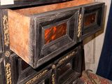 a wooden cabinet with a drawer on top of it
