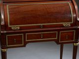 an antique writing desk with two drawers and gold trimmings