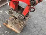 a red machine that is sitting on the ground