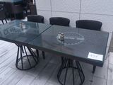 a glass table with chairs around it on the floor