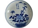 three plates with blue and white designs on them