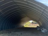 a large metal structure that is sitting in the middle of a field